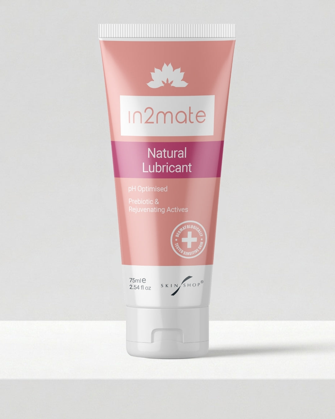 A squeeze tube of in2mate Natural Lubricant for intimate skin by Skin Shop, featuring a pink and magenta gradient design with a white cap, set against a clean light grey background.
