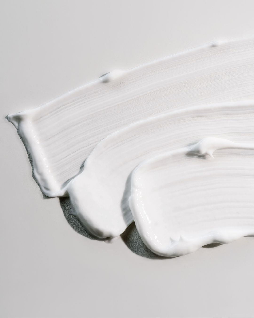 Close-up of the smooth white Boswellia & Commiphora cream, showing its rich, non-greasy texture