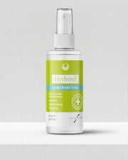 A 100ml white spray bottle of Hydrosil Scalp Shield Tonic, with its green and blue label and fine-mist pump, the leave-in scalp tonic for dry, itchy scalps.