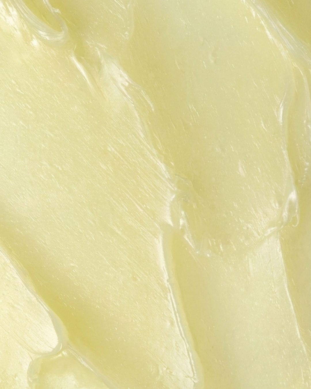 Close-up of the smooth, pale yellow LipQ Liquorice Lip Balm texture, swiped to show its soft, glossy balm consistency