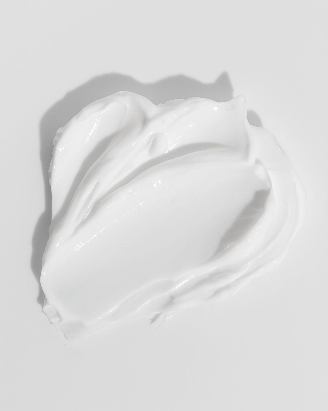 A rich swatch of PSOregon Intensive Serum showing its thick, concentrated, non-greasy white texture that soaks into sore, scaly patches of skin